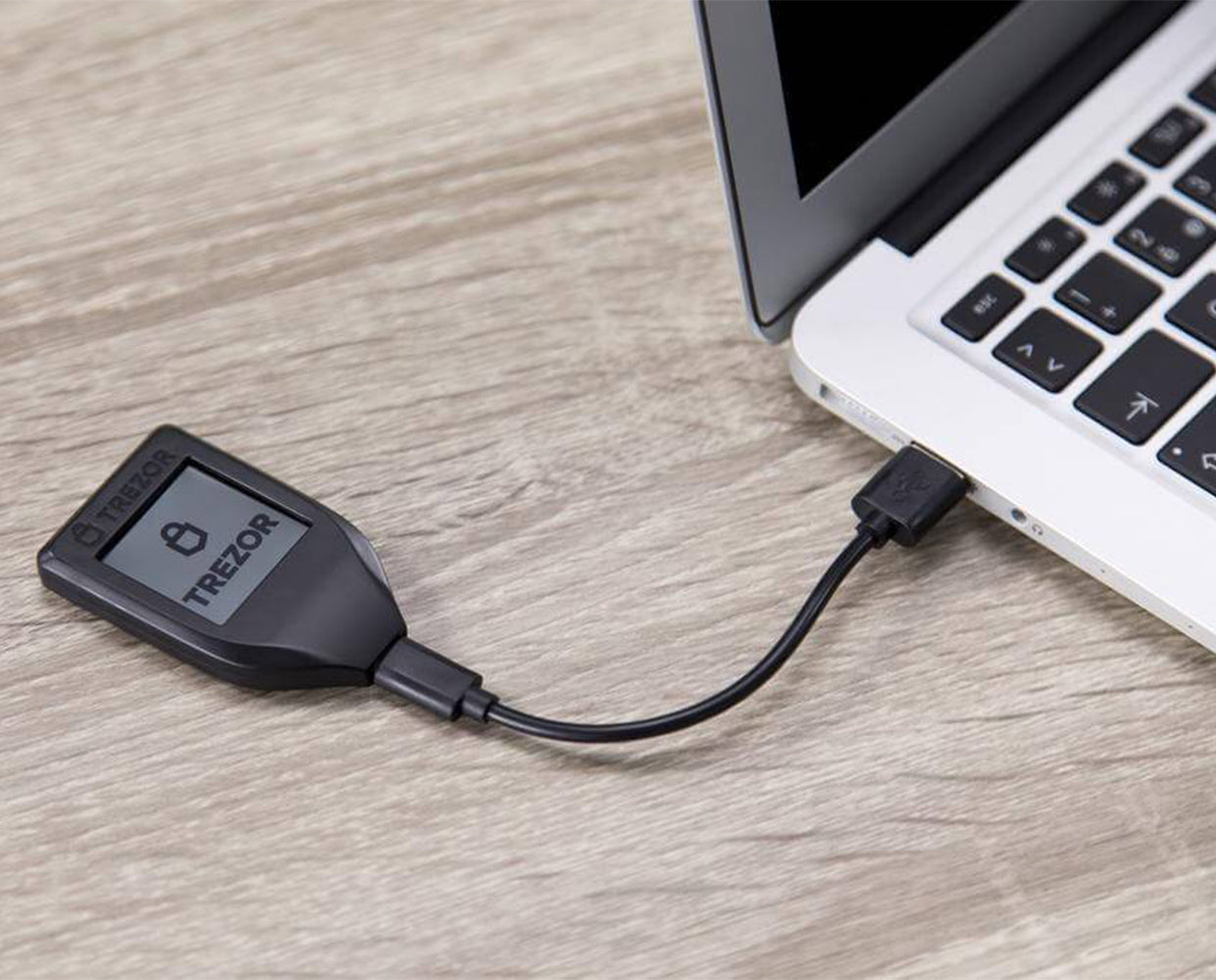 Trezor Model T hardware wallet connected to a laptop